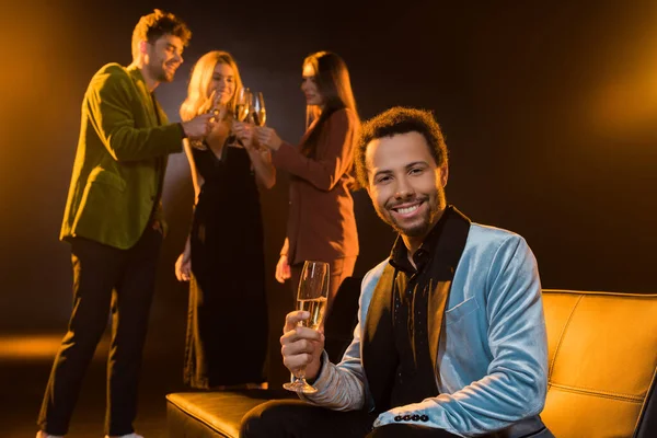 Happy African American Man Sitting Sofa Holding Glass Champagne Friends — Stock Photo, Image