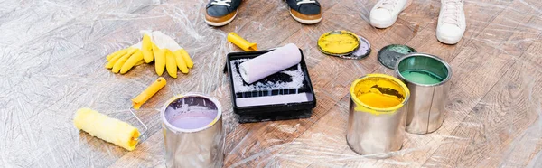 Cropped View Couple Feet Tins Paint Gloves Rollers Tray Floor — Stock Photo, Image