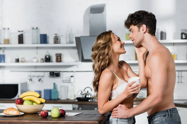 Smiling Woman Bra Holding Cup Touching Sexy Boyfriend Kitchen — Stock Photo, Image