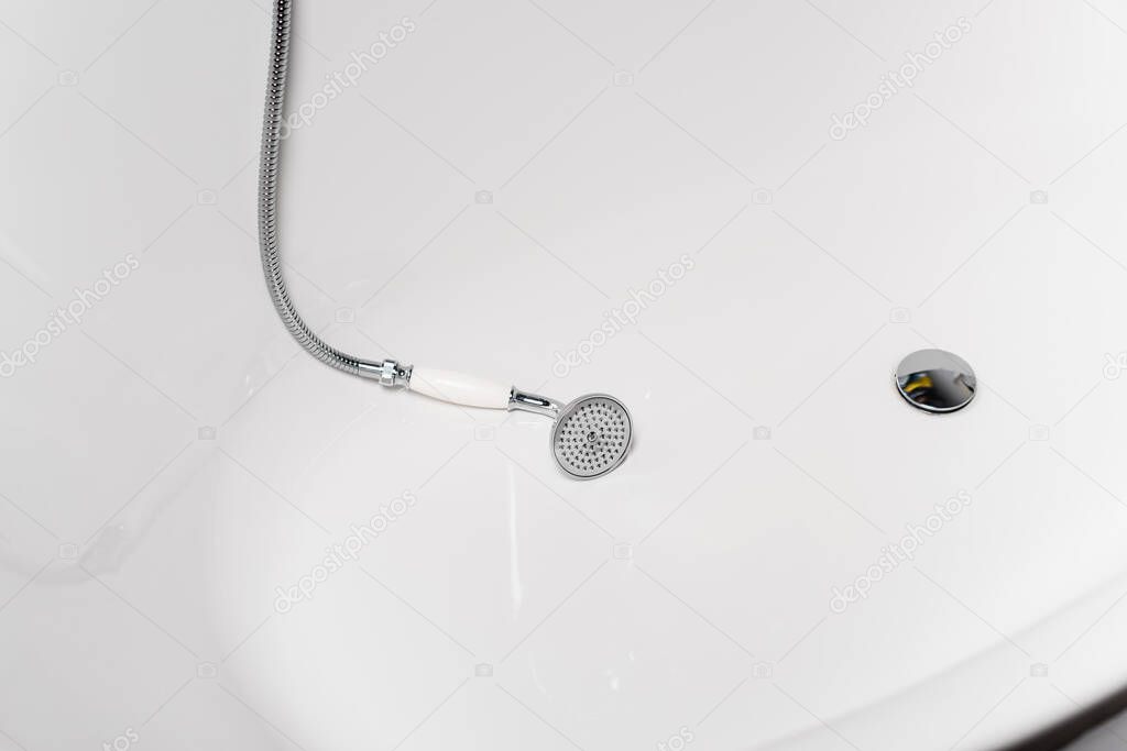 High angle view of shower in white bathtub 