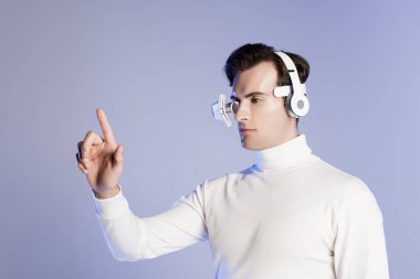 Cyborg in eye lens and headphones touching something isolated on purple clipart