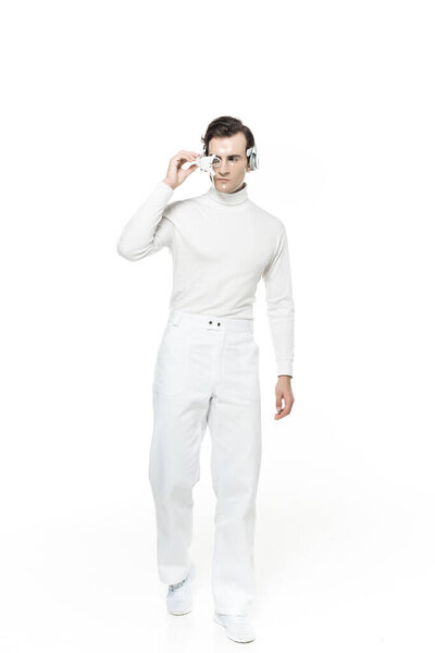 Full length of cyborg in headphones and digital eye lens isolated on white
