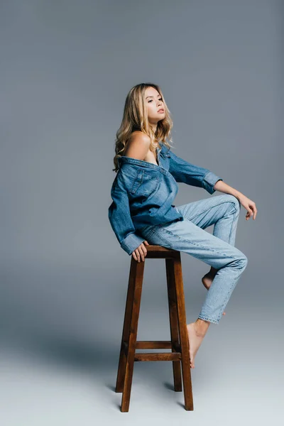 Seductive Young Woman Denim Shirt Jeans Naked Shoulder Sitting High — Stock Photo, Image