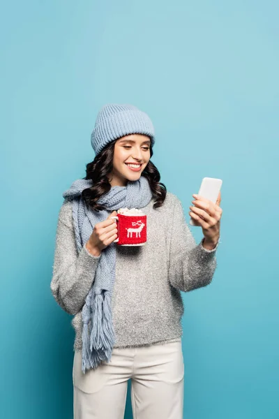 Happy Brunette Woman Scarf Hat Looking Smartphone While Holding Cup — Stock Photo, Image