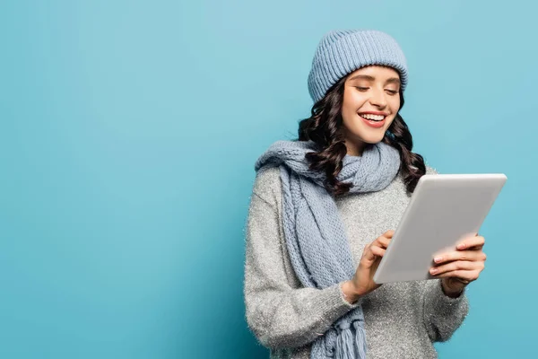 Cheerful Brunette Woman Hat Scarf Using Digital Tablet Isolated Blue — Stock Photo, Image