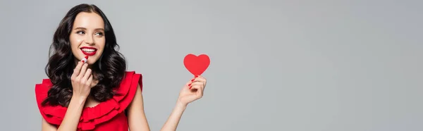 Cheerful Young Woman Holding Red Paper Heart Lipstick Isolated Grey — Stock fotografie