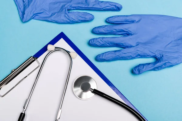 Top View Clipboard Stethoscope Latex Gloves Blue Background — Stock Photo, Image