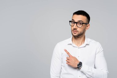 İspanyol iş adamının gri üzerine izole edilmiş kameraya bakarken parmağıyla işaret etmesine şaşırdım.