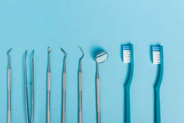 Top View Stainless Dental Tools Toothbrushes Blue Background — Stock Photo, Image