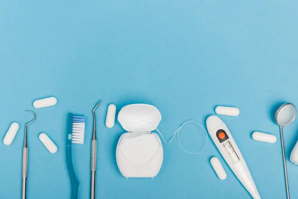 Top View Dental Tools Pills Thermometer Blue Background — Stock Photo, Image