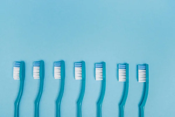 Draufsicht Auf Blaue Zahnbürsten Auf Blauem Hintergrund Mit Kopierraum — Stockfoto