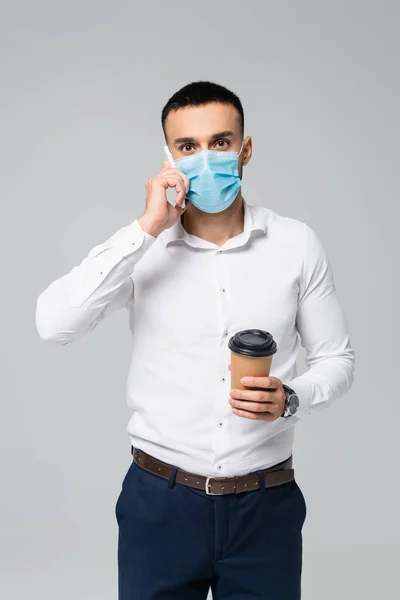 Young Hispanic Businessman Medical Mask Talking Smartphone Holding Coffee Isolated — Stock Photo, Image