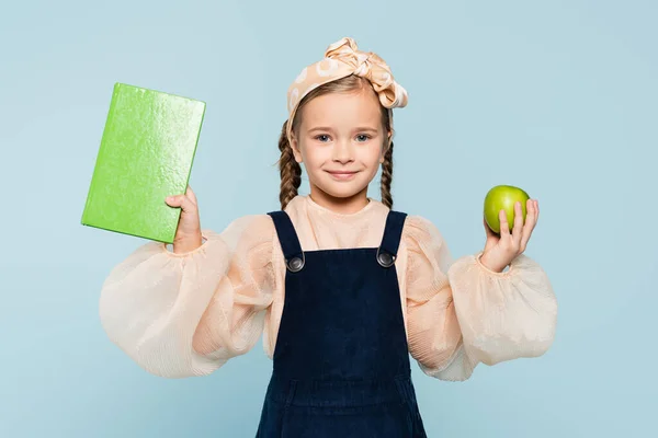 Smart Kid Smiling While Holding Book Green Apple Isolated Blue — Stock Photo, Image