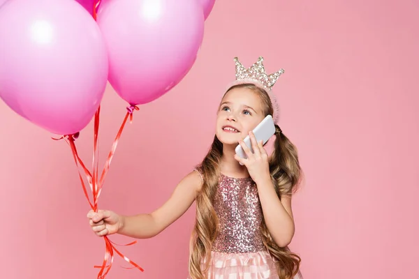 Cheerful Little Girl Dress Crown Holding Balloons Talking Smartphone Isolated — Stock Photo, Image