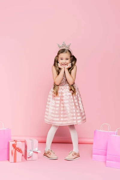 Full Length Excited Little Girl Crown Standing Presents Shopping Bags — Stock Photo, Image