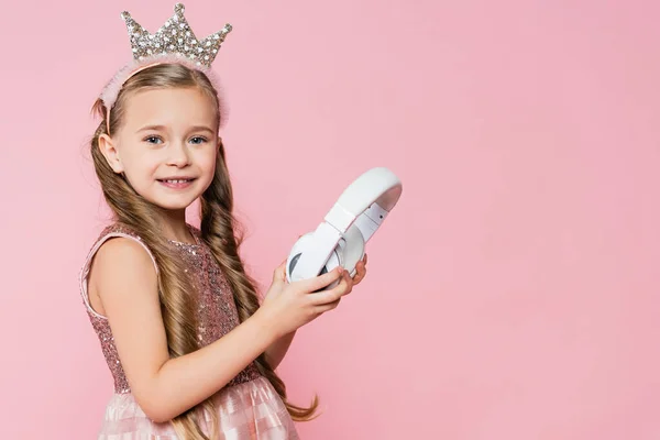 Happy Little Girl Crown Holding Wireless Headphones Isolated Pink — Stock Photo, Image