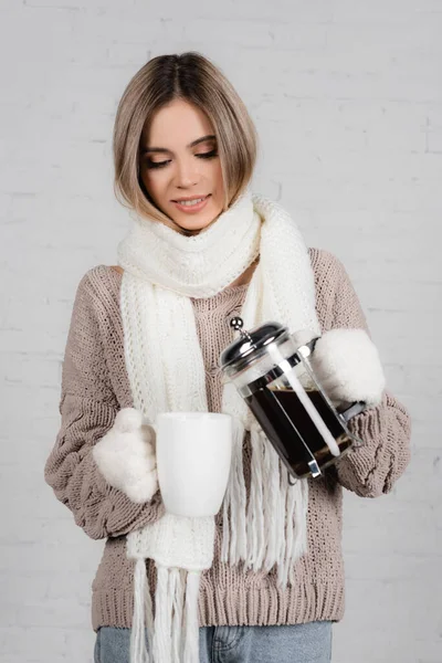 Smiling Woman Warm Sweater Gloves Scarf Pouring Coffee Cup White — Stock Photo, Image