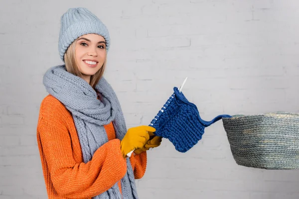 Cheerful Woman Looking Camera While Knitting Basket White Brick Wall — Stock Photo, Image