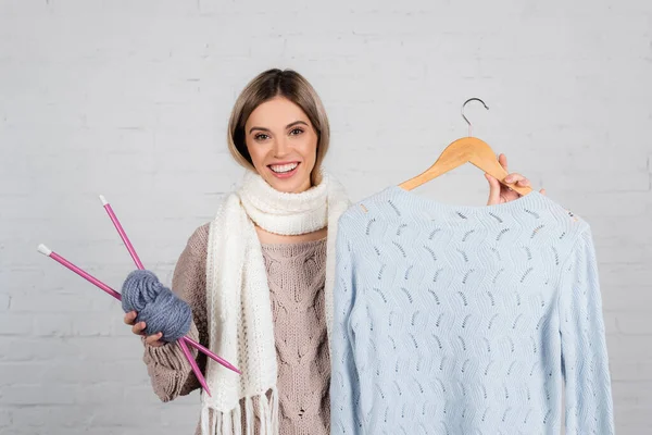 Smiling Woman Holding Hanger Sweater Yarn Knitting Needles White Background — Stock Photo, Image