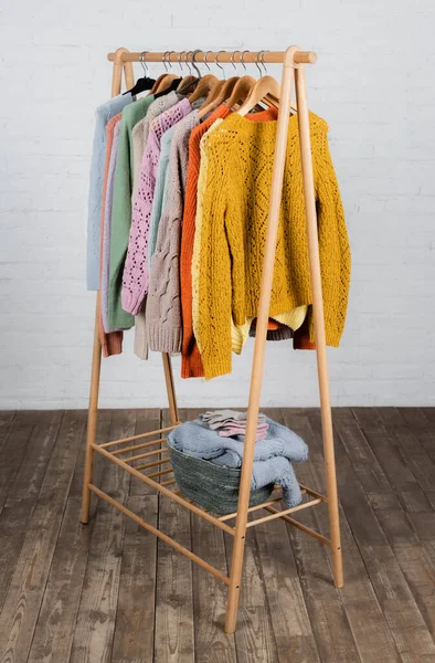 Warm Knitted Sweaters Gloves Hanger Rack White Brick Wall — Stock Photo, Image