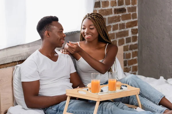 Smiling Woman Feeding African American Boyfriend Blubbery Breakfast Tray Bed — Stock Photo, Image