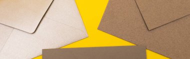 top view of paper envelopes isolated on yellow, banner clipart