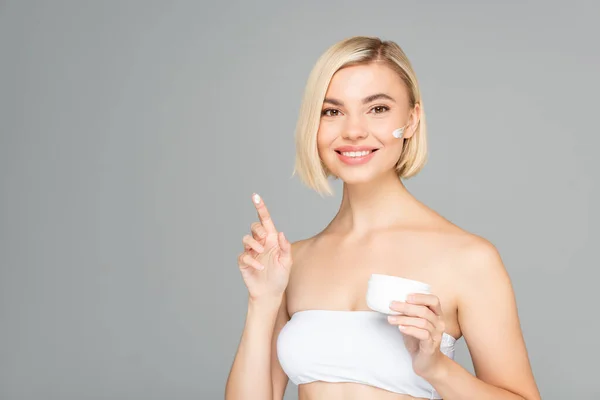 Mujer Sonriente Sosteniendo Crema Cosmética Dedo Aislado Gris — Foto de Stock