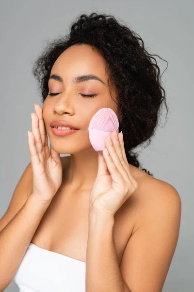 Pleased African American Woman Closed Eyes Holding Silicone Cleanser Isolated — Stock Photo, Image