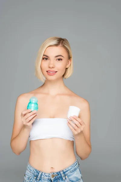 Blonde Woman Looking Camera While Holding Deodorant Cap Isolated Grey — Stock Photo, Image
