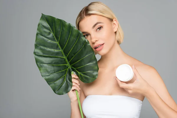 Woman Cosmetic Cream Tropical Leaf Looking Camera Isolated Grey — Stock Photo, Image