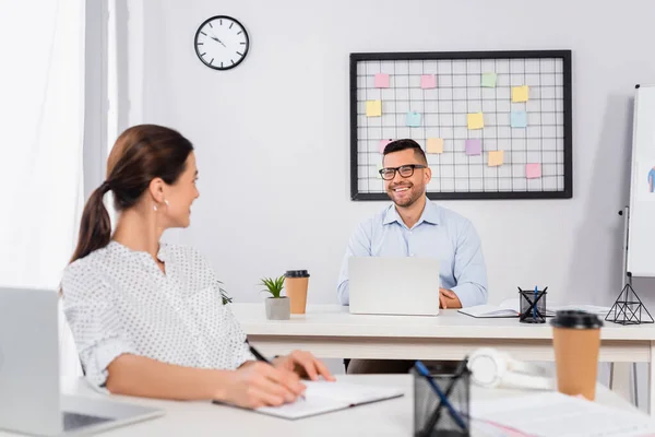 Happy Businessman Glasses Looking Businesswoman Writing Notebook Blurred Foreground — Stock Photo, Image