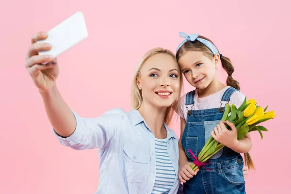 Mother Taking Selfie Cheerful Daughter Holding Tulips Isolated Pink — Stock Photo, Image