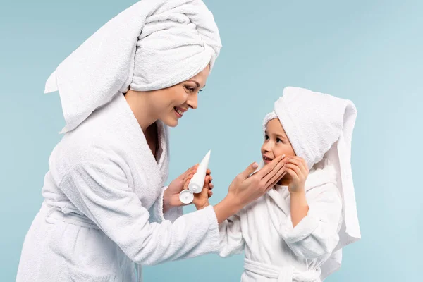 Happy Mother Bathrobe Holding Tube Applying Cosmetic Cream Face Daughter — Stock Photo, Image
