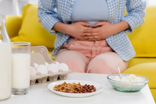 Cropped View Milk Eggs Cottage Cheese Nuts Woman Allergy Blurred — Foto Stock