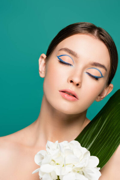 portrait of charming woman with closed eyes near white peony and green leaf isolated on green