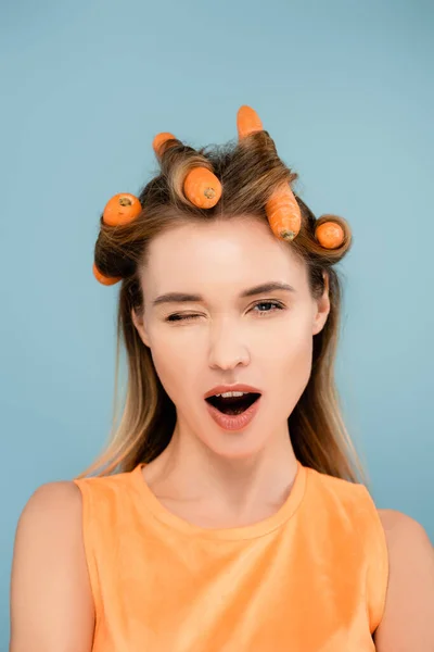 Flirty Woman Carrots Instead Curlers Winking Camera Isolated Blue — Stock Photo, Image