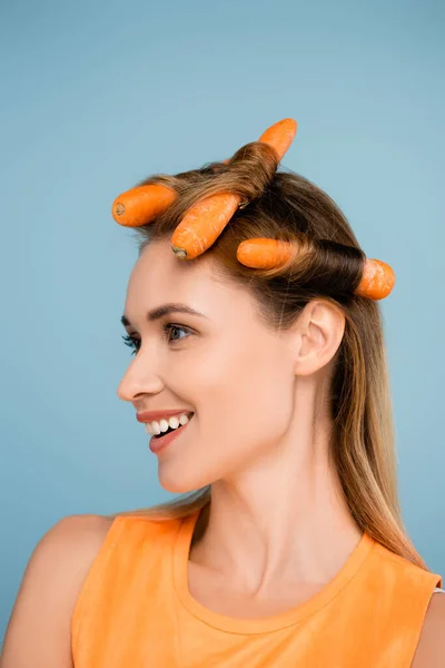 Smiling Woman Looking Away While Curling Hair Fresh Carrots Isolated — Stock Photo, Image