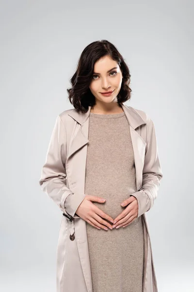 妊娠中女性でコート見ますでカメラ絶縁オングレー — ストック写真