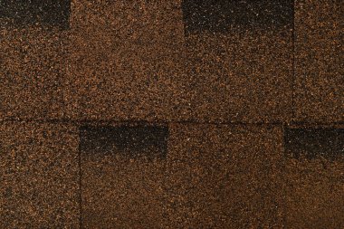 brown, grainy background of bituminous roofing tiles, top view clipart