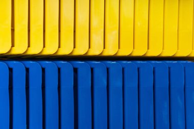 background of yellow and blue plastic elements, top view clipart