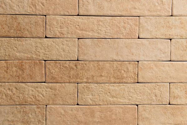 задний план бледно-коричневой стены, из натурального кирпича, вид сверху