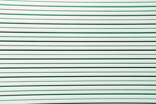 background of white horizontal rows of plastic elements, top view