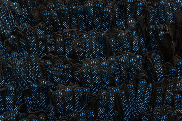 Mavi Kauçuk Noktalı Siyah Eldivenlerinin Arka Planı Üst Görünüm — Stok fotoğraf