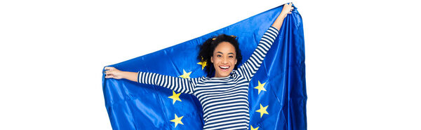 joyful african american woman holding flag of european union isolated on white, banner