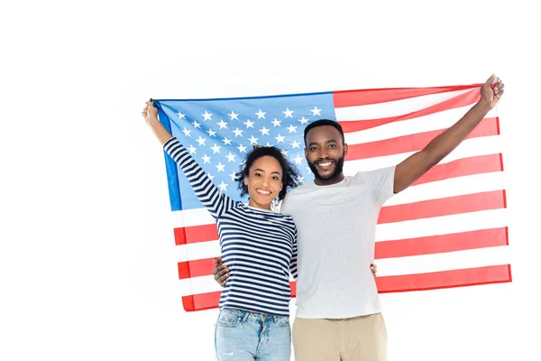 stock image joyful african american couple holding usa flag while looking at camera isolated on white