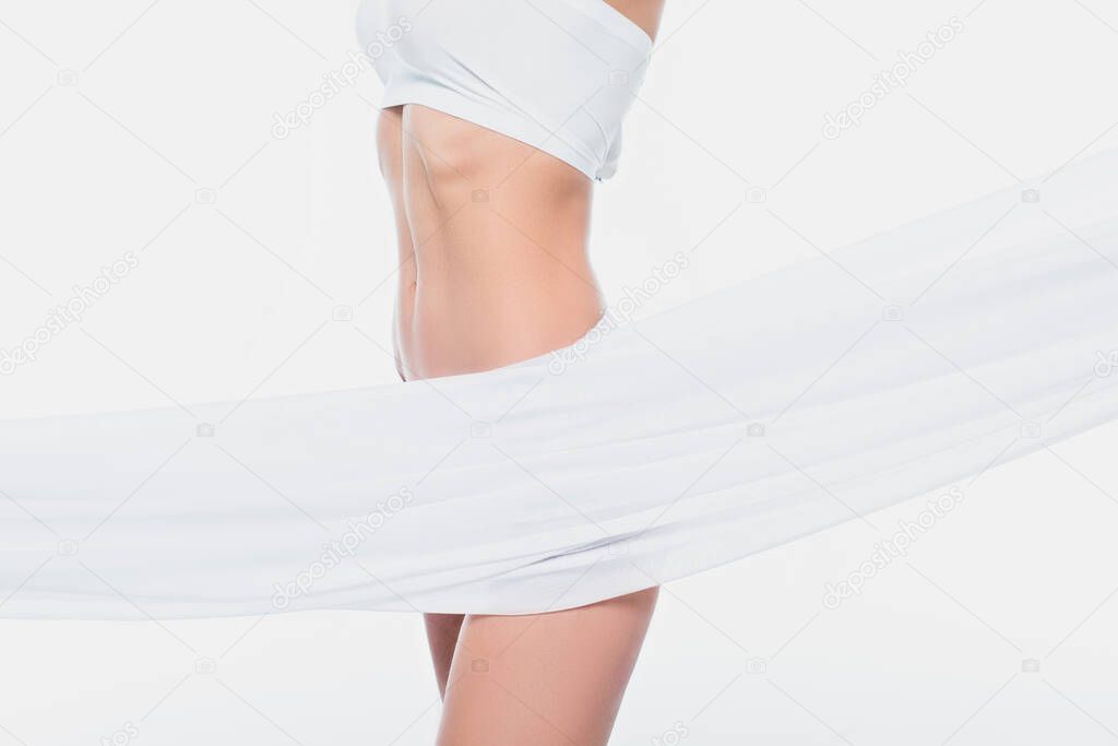 Partial view of slim woman in bra and cloth isolated on white 