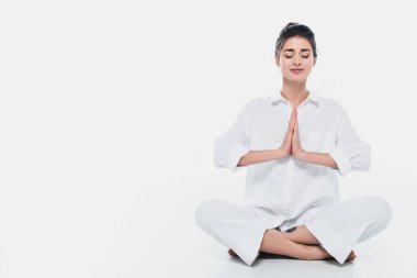 Brunette woman in white clothes practicing yoga on white background  clipart