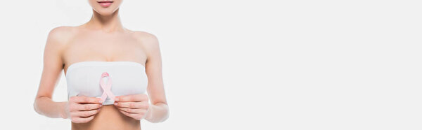 Cropped view of woman in bra holding ribbon of breast cancer awareness isolated on white, banner 