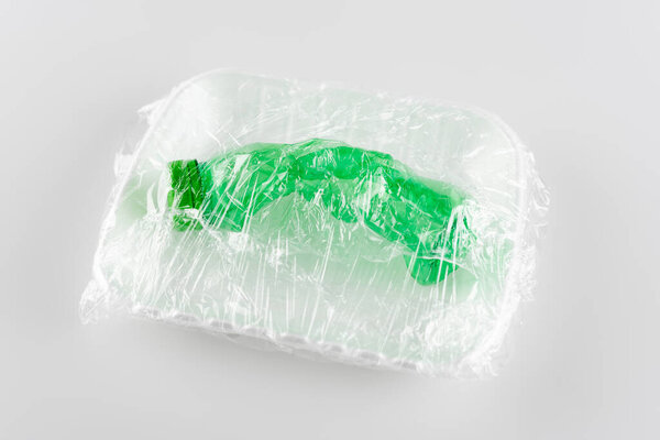 used plastic bottle packed in cellophane, ecology concept
