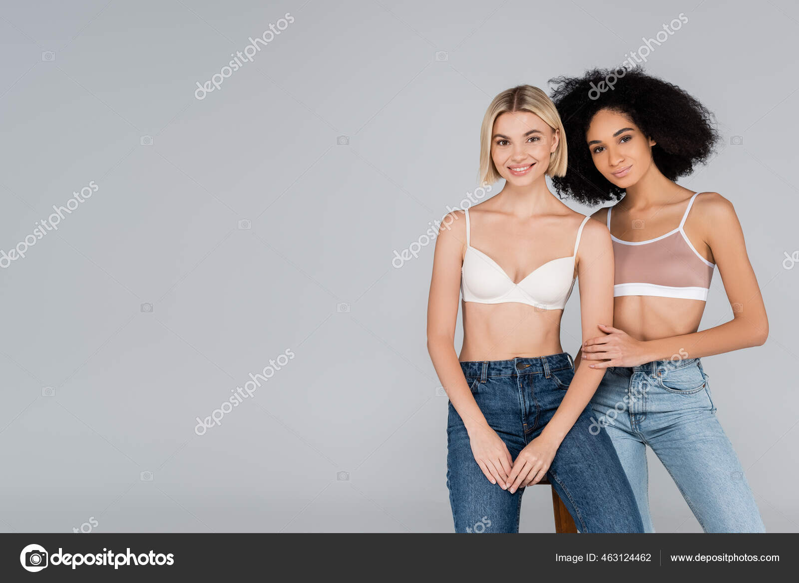 Young Interracial Women Bras Jeans Looking Camera Isolated Grey